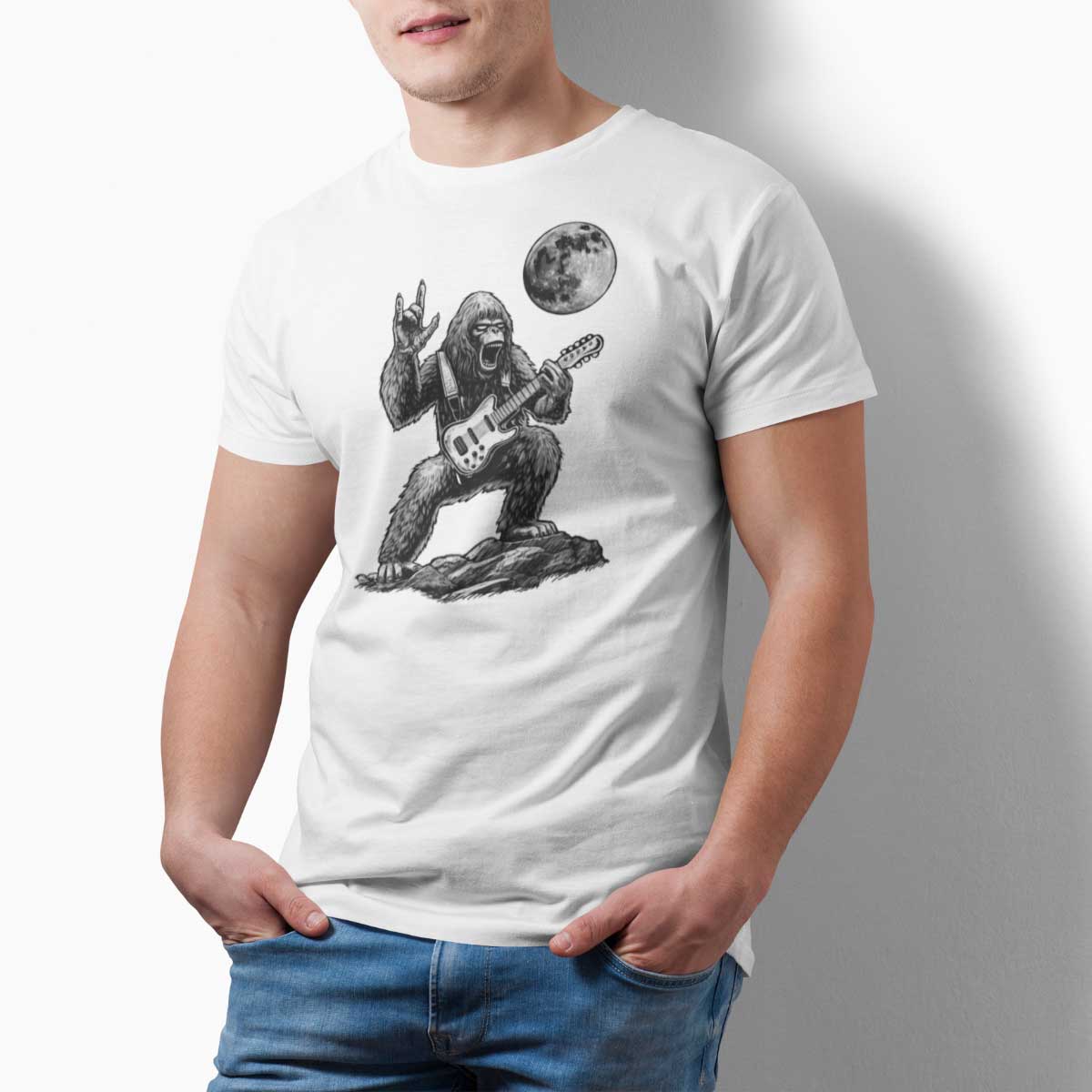 Person wearing a white t-shirt with a graphic of a gorilla playing guitar and a moon above it.